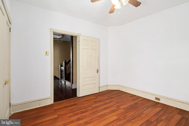 unfurnished bedroom with wood finished floors, a ceiling fan, and baseboards