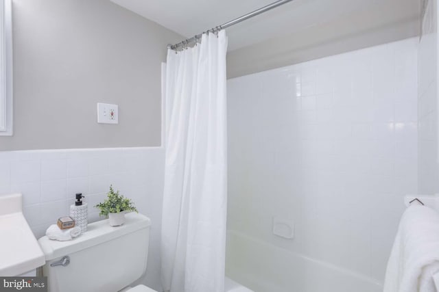 full bathroom with toilet, vanity, shower / bathtub combination with curtain, and tile walls