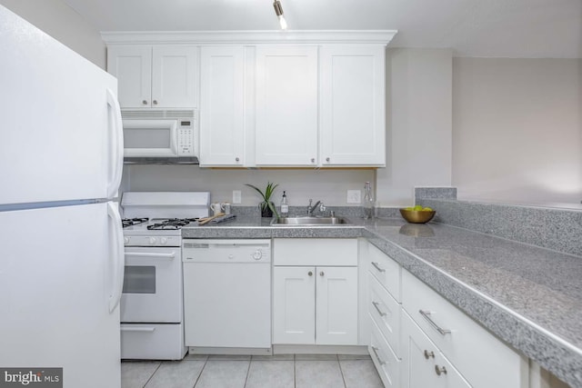 kitchen featuring sink, light tile patterned floors, white cabinets, and white appliances