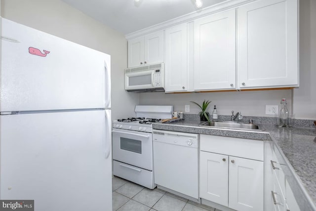 kitchen featuring white cabinetry, sink, white appliances, and light tile patterned flooring