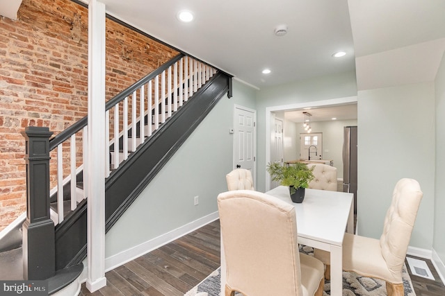 dining room featuring sink and dark wood-type flooring