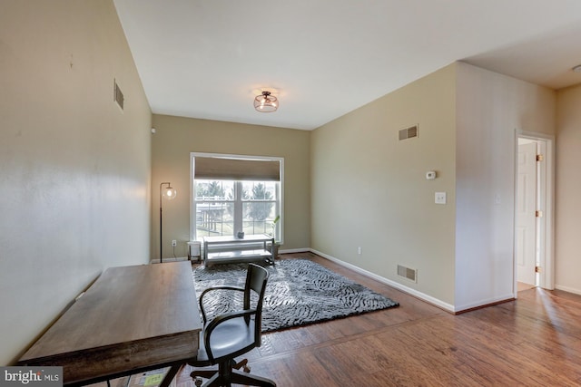 office area featuring wood finished floors and visible vents