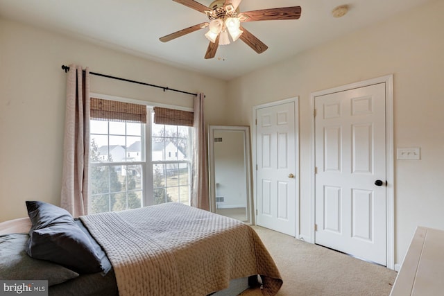 bedroom with light carpet and ceiling fan