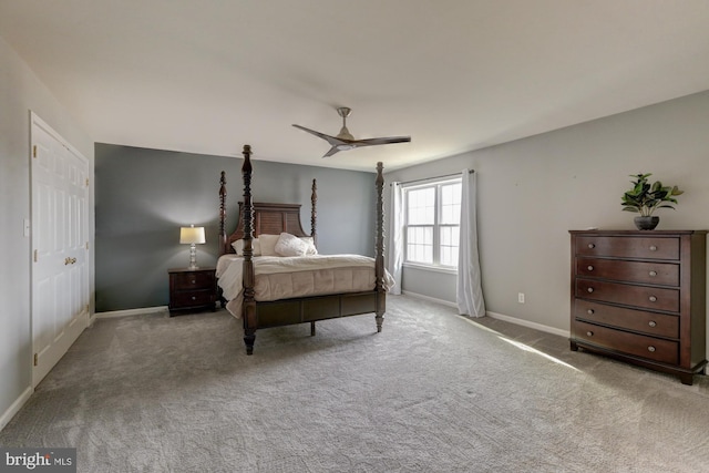 bedroom with baseboards, a ceiling fan, and light colored carpet