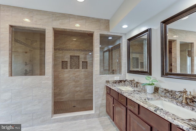 full bath with recessed lighting, double vanity, a sink, and a walk in shower