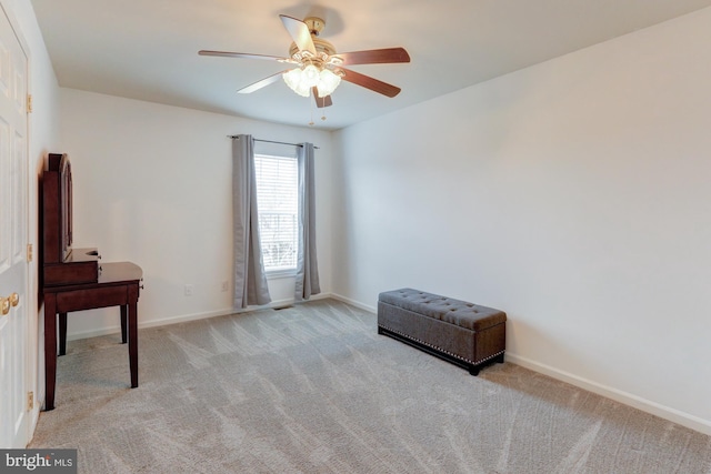 interior space featuring a ceiling fan, light colored carpet, and baseboards