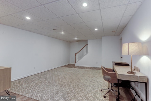 home office featuring baseboards, a drop ceiling, light wood-type flooring, and recessed lighting