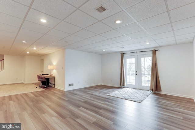 interior space with light wood finished floors, visible vents, and french doors