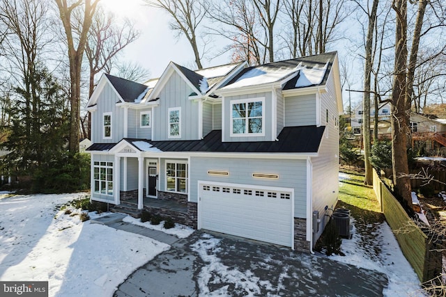 view of front of house with a garage and central AC unit