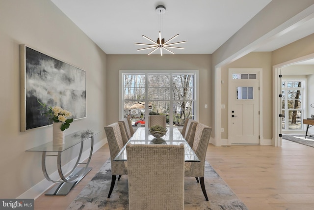 dining area featuring a chandelier and light hardwood / wood-style flooring