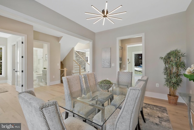 dining room with a chandelier and light wood-type flooring