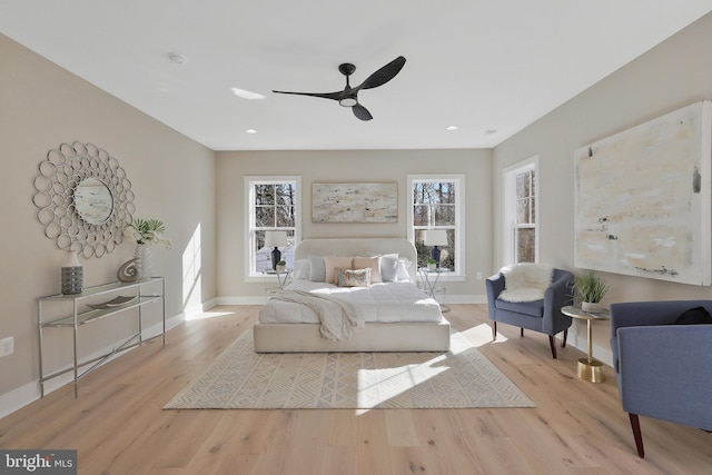 bedroom with light hardwood / wood-style floors and ceiling fan