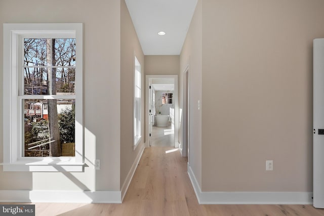 corridor with light hardwood / wood-style flooring