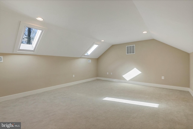 additional living space featuring lofted ceiling and light colored carpet