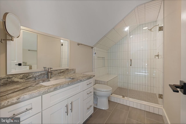 bathroom featuring vanity, an enclosed shower, vaulted ceiling, tile patterned floors, and toilet