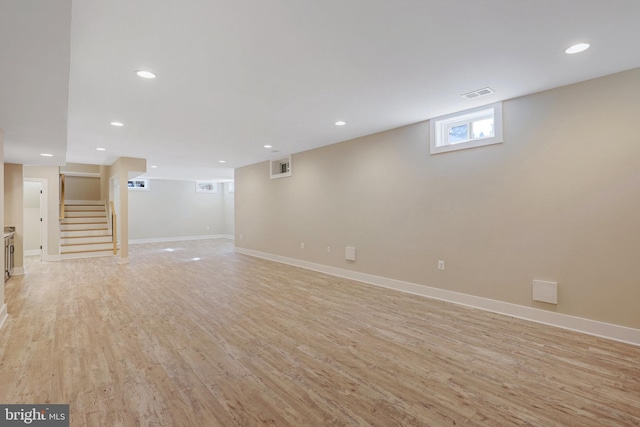 basement with light hardwood / wood-style floors