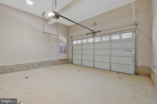 garage with a garage door opener and electric panel