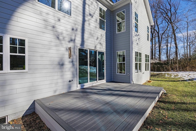 wooden terrace featuring a yard