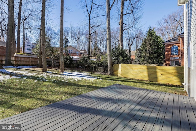 wooden terrace with a lawn