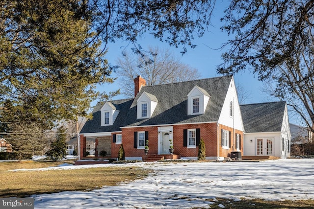 new england style home with cooling unit