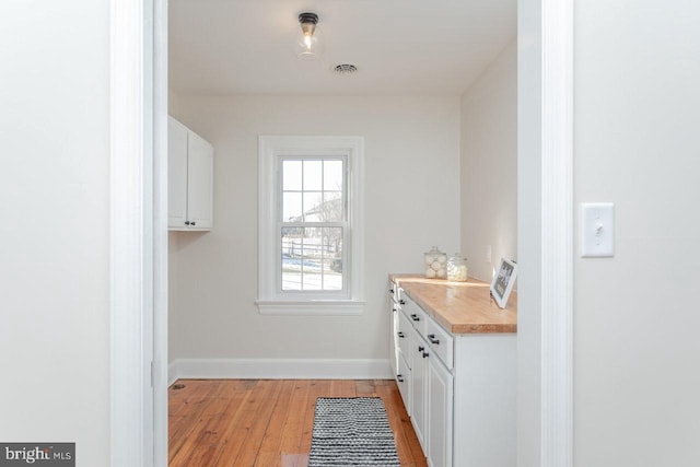 laundry area with light hardwood / wood-style flooring