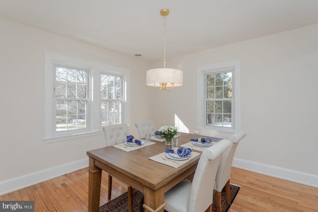 dining space with plenty of natural light and light wood-type flooring