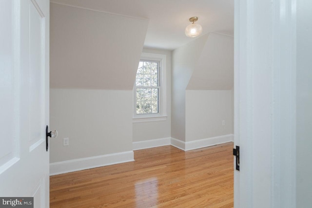 bonus room featuring lofted ceiling and light wood-type flooring