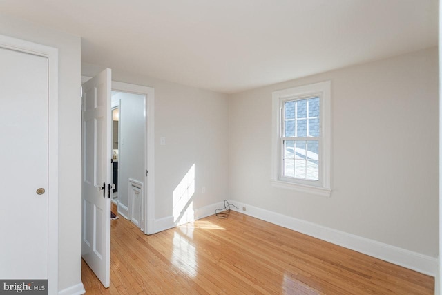 empty room with light hardwood / wood-style flooring