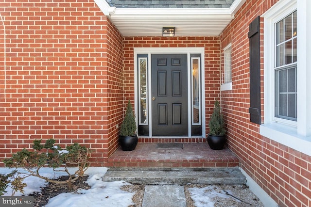 view of snow covered property entrance