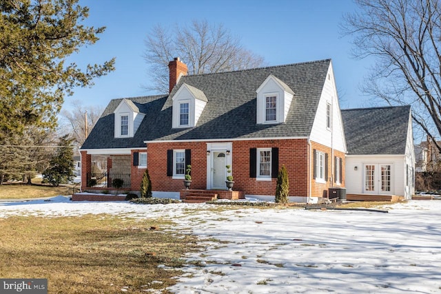 new england style home featuring a yard and central air condition unit