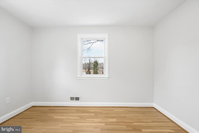 empty room with light hardwood / wood-style flooring