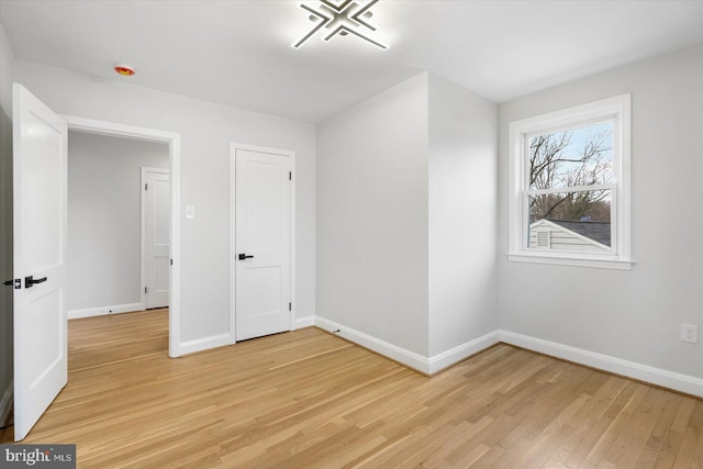 unfurnished bedroom featuring light wood-type flooring