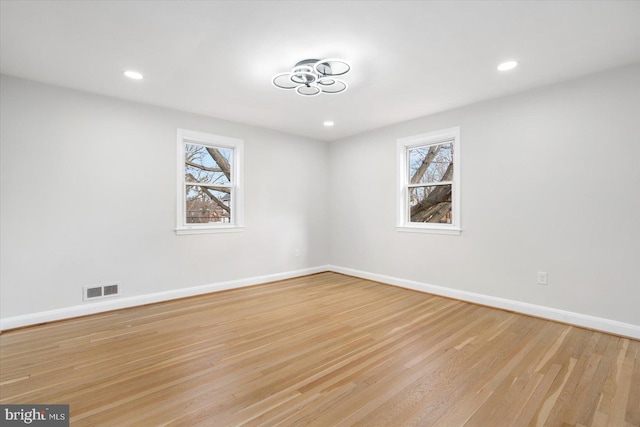 spare room with light hardwood / wood-style floors