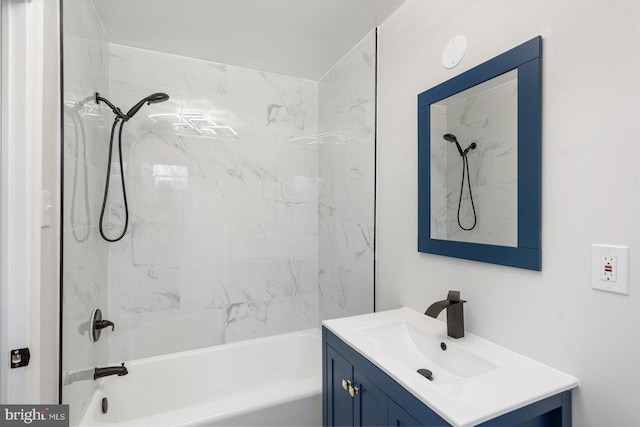 bathroom with tiled shower / bath and vanity