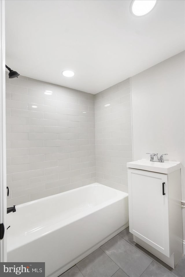 bathroom with vanity, tile patterned floors, and tiled shower / bath