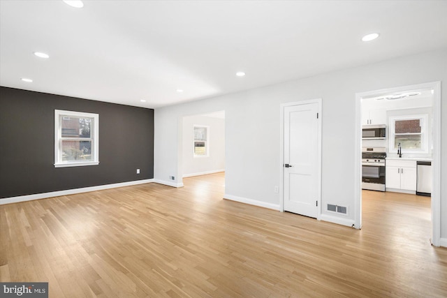 unfurnished living room featuring light hardwood / wood-style flooring