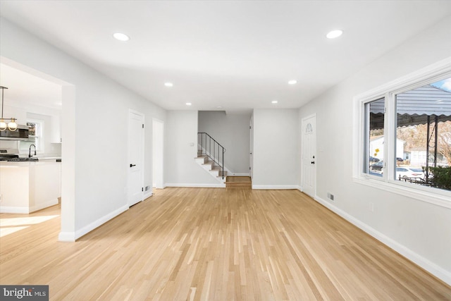 unfurnished living room featuring light hardwood / wood-style flooring