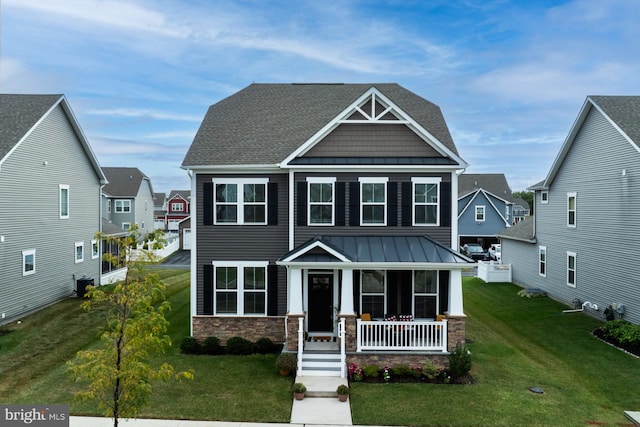 craftsman inspired home featuring central AC, covered porch, and a front lawn