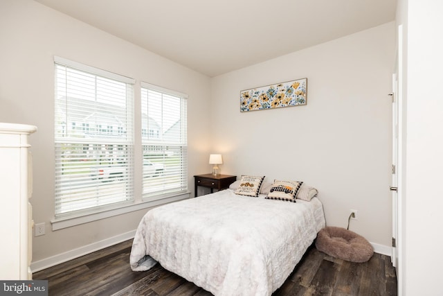 bedroom with dark wood-type flooring