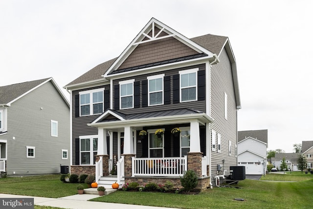 craftsman house with a garage, a front yard, central air condition unit, and covered porch