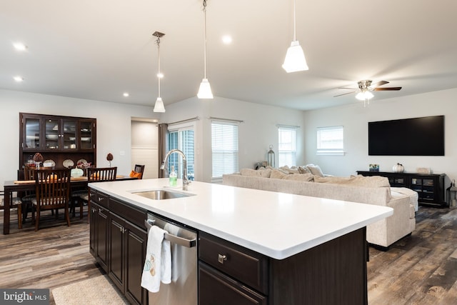 kitchen featuring dishwasher, pendant lighting, a kitchen island with sink, and sink