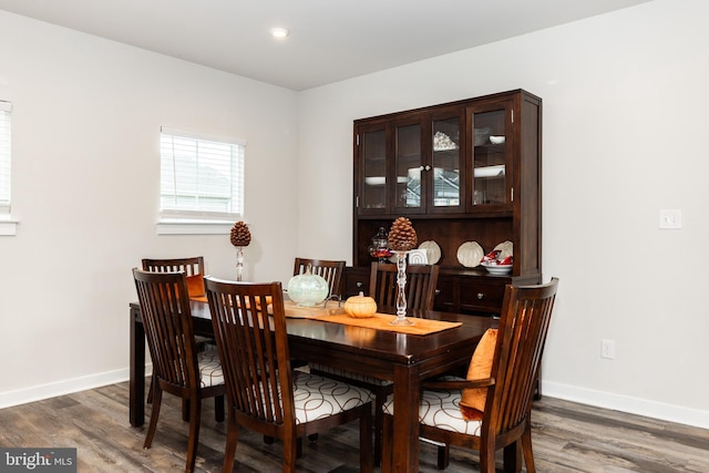 dining space with dark hardwood / wood-style flooring