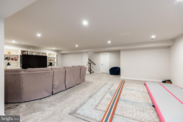 living room featuring light colored carpet and built in features