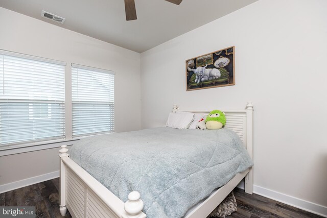 bedroom with dark wood-type flooring and ceiling fan