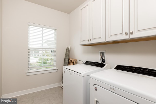 laundry area featuring separate washer and dryer and cabinets