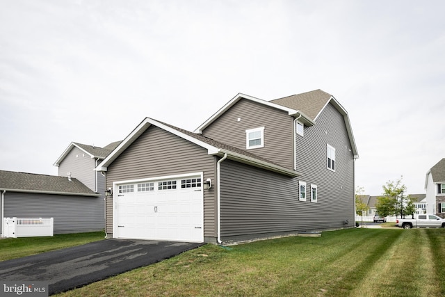 view of property exterior featuring a garage and a lawn