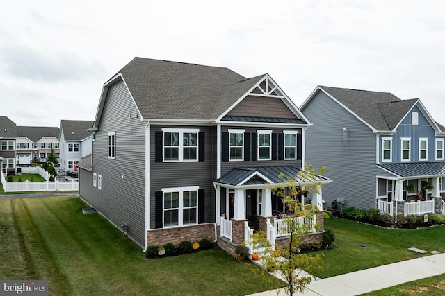 craftsman-style house featuring a porch and a front lawn