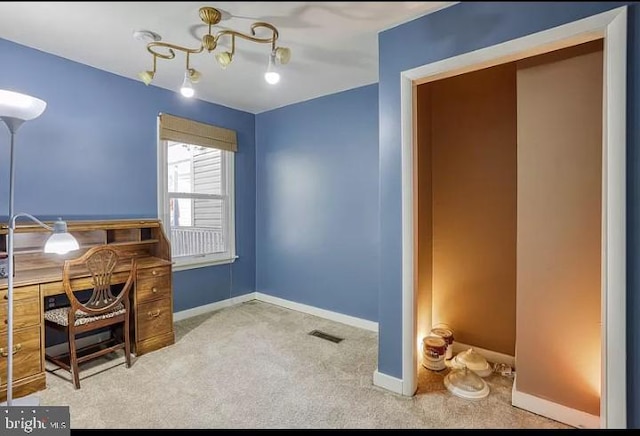 office area with carpet floors and a chandelier