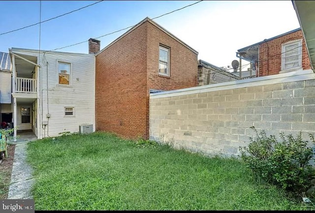 view of side of home featuring a lawn