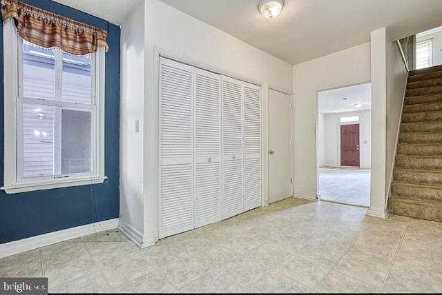 unfurnished bedroom with multiple windows and a closet